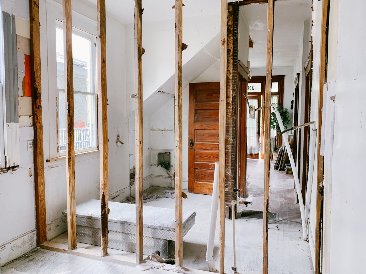 The Art of Drawing Readers In: Your attractive post title goes here Interior view of a home under renovation with exposed wooden beams and door.
