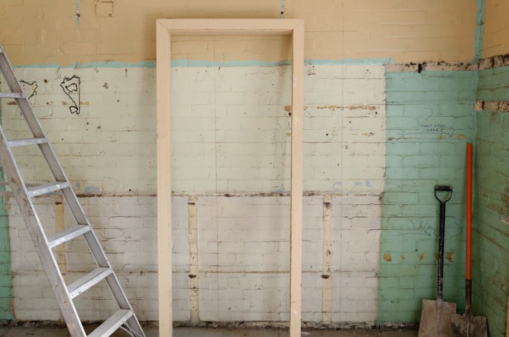 Mastering the First Impression: Your intriguing post title goes here Renovation scene featuring ladder, frame, and tools against partially demolished walls.
